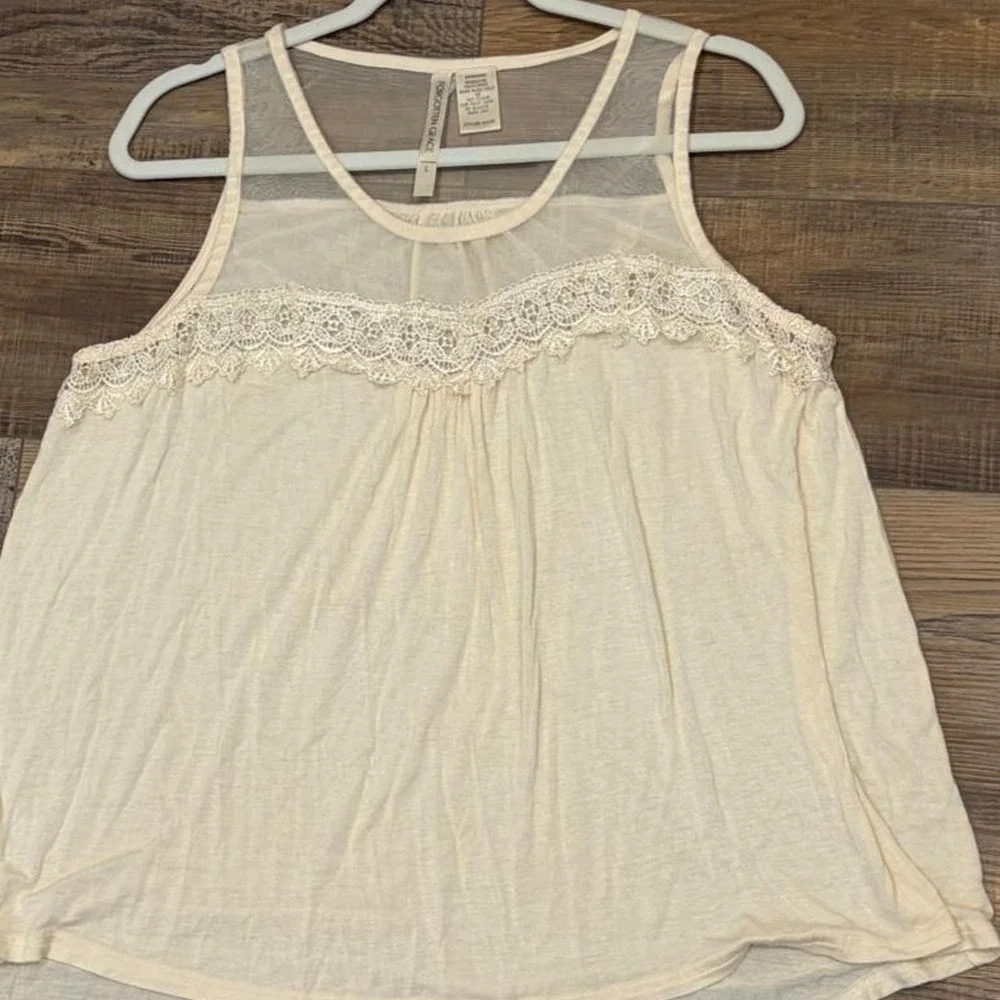 Cream lace tank top with sheer mesh and lace trim on the shoulders